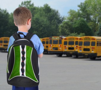 School Boy Looking at Bus with Bookbag