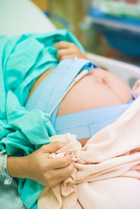 pregnant female feeling the pain of contraction labor in hospital